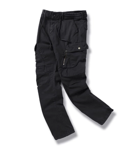 Detail view of men's black cargo pants showing elastic waist and side flap pockets