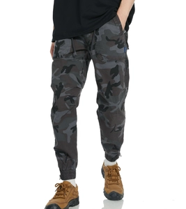 Detail of men's camouflage cargo pants showing elastic cuffs and durable fabric