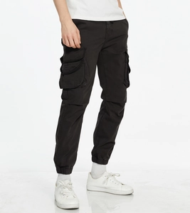Detailed view of cargo jogger pants featuring multi-pocket design and elastic ankle cuffs