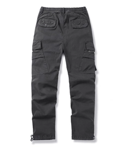 Detailed view of elastic waistband and functional cargo pockets on outdoor trousers