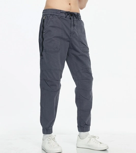 Detail of dark grey cargo joggers featuring elastic drawstring waist and side zip pockets