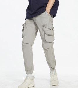 Detail view of large cargo pockets and premium twill fabric on light grey men's joggers