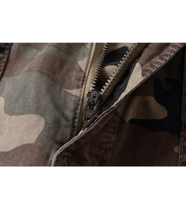 Macro shot of durable metal zipper fly on camouflage tactical pants with twill fabric detail