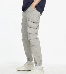 Detail view of light grey cargo jogger pants with large side pockets and ribbed cuffs