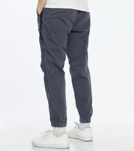 Detailed back view of dark grey cargo pants featuring zip pockets and elastic cuffs