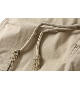 Detailed close-up of khaki cotton twill pants featuring an adjustable braided drawstring waist