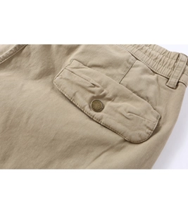 Detail of khaki casual pants featuring elastic drawstring waist and cargo pocket with button