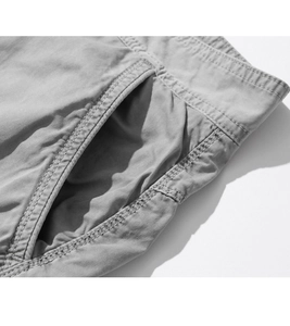 Detail shot of grey cargo shorts featuring reinforced side pockets and twin needle stitching