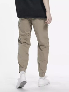 Men's khaki jogger cargo pants featuring elastic cuffs and knee seam details