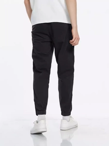 Men's black cargo joggers with elastic cuffs and back pocket view in studio setting