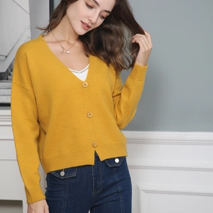 Detail showing the ribbed cuffs and soft knit texture of this V-neck yellow cardigan sweater