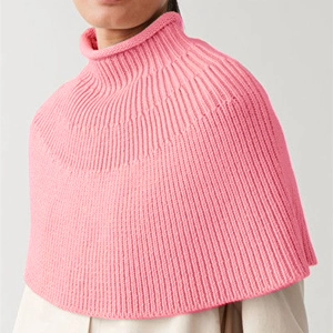 Pink chunky knit turtleneck poncho vest with ribbed texture and chic rolled collar design