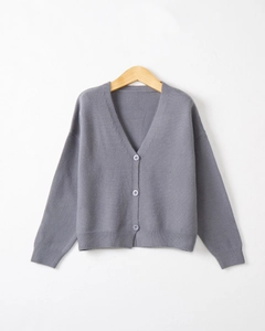 Close-up of grey V-neck knitted cardigan showing fine knit texture and matching buttons