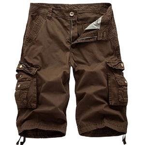 Macro view of dark brown cargo shorts showing cotton twill fabric and pocket details