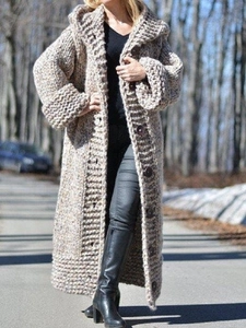 Close-up of thick chunky knit cardigan with hooded design and round button details