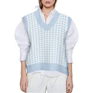 Detailed view of light blue houndstooth knit vest with V-neck and ribbed hem texture