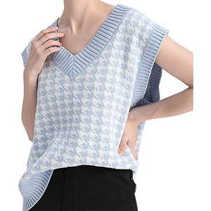 Detail of V-neck knitted vest with light blue houndstooth pattern and ribbed edges