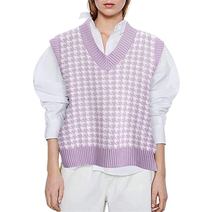 Detail of lavender houndstooth knitted vest featuring V-neck and ribbed edges on model