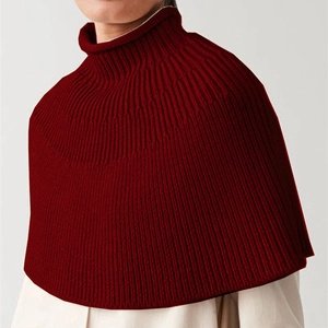 Macro detail of dark red high-neck ribbed knit shawl showing premium vertical texture