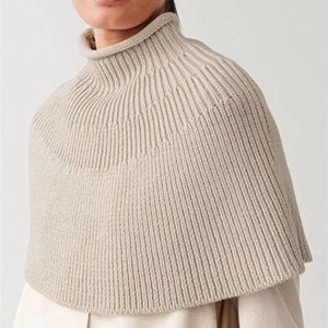 Detailed close-up of ribbed knit texture on oatmeal high-neck sleeveless shawl wrap