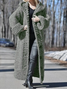 Close-up of thick knit grey hooded cardigan showing sleeve texture and front buttons