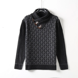 Close-up of thick knit sweater with buckle collar and textured honeycomb pattern
