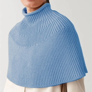 Macro detail of sky blue ribbed knit turtleneck shawl showing the fine texture