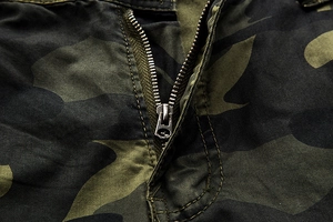 Macro detail of high-quality silver metal zipper on durable camouflage cargo shorts