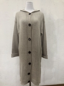 Detailed knit texture of oatmeal hooded long cardigan with large dark brown buttons