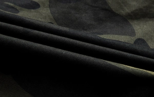 Macro view of durable twill cotton fabric with classic jungle camouflage pattern