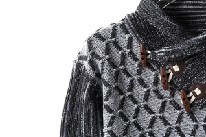 Detailed view of turtle neck collar with leather buckle and textured honeycomb knit pattern