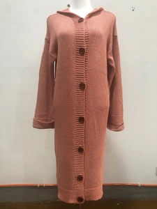 Close-up of thick knit texture and brown buttons on a long hooded pink cardigan