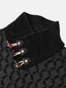 Detail of high neck knit sweater featuring leather buckle and wooden toggle buttons
