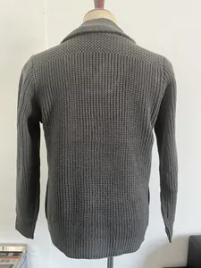 Detail view of dark grey men's knit sweater showing rib-knit cuffs and hem on the back