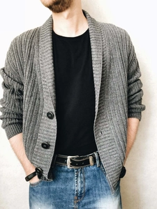 Detailed texture of men's grey cable knit cardigan with shawl collar and buttons