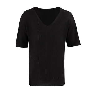 Detail of black V-neck knit shirt showing fine ribbed texture and premium craftsmanship