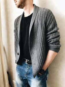 Detail of the chunky knit ribbed texture and shawl collar on a grey cardigan for men