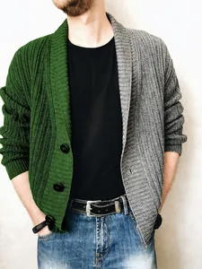 Detail of the thick rib-knit texture and green-grey contrast paneling on male cardigan