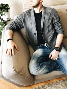 Close-up of men's gray shawl collar cardigan showing ribbed texture and button details
