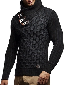 Detail of black heavy knit sweater featuring honeycomb texture and leather buckle collar