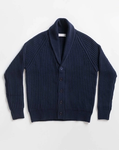Macro shot of navy blue shawl collar knit cardigan with vertical ribbed texture and buttons