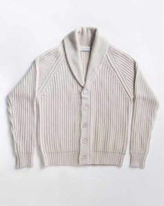 Detail of cream knit cardigan featuring a shawl collar and ribbed texture with five buttons