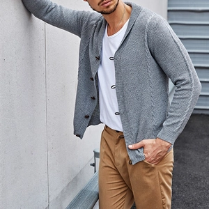 Detail of grey men's knit cardigan showing waffle texture and dark amber buttons