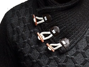 Detail of chunky knit sweater collar featuring wooden toggle buttons and leather patches