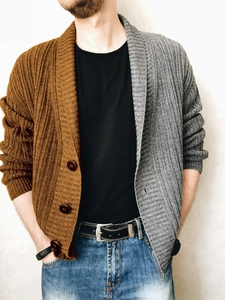 Detail of two-tone knit cardigan with cable textures and large buttons on men sweater