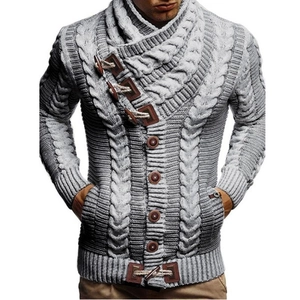 Macro detail of men's cable knit cardigan featuring faux leather straps and toggle buttons