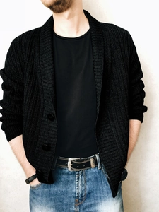 Close-up of men's black ribbed knit cardigan with button-down front and slim fit design