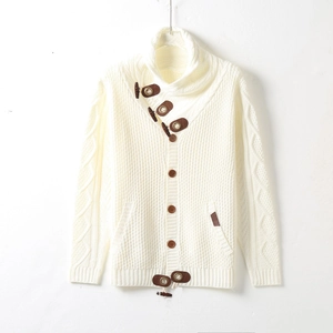 Detailed view of men's cable knit cardigan featuring brown leather horn button accents