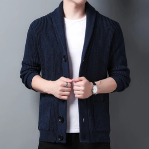 Close-up of navy blue men's knitted cardigan featuring thick texture and large black buttons