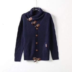 Detailed knit pattern on dark blue men's cardigan with horn button and leather accents